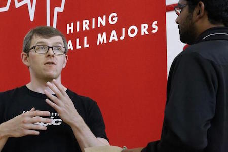 In this Sept. 25, 2014 file photo, Jacob Robinson, left, of Epic, an electronic health record software company, speaks with students attending The Foot in the Door Career Fair at the University of Illinois Springfield in Springfield, Ill. The Labor Department issued its November report on job openings and labor turnover on Tuesday, Jan. 13, 2015. (AP Photo/Seth Perlman, File)