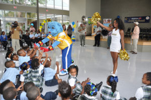 Power Panther, New Orleans Saints cheerleaders, and The Original Royal Players Brass Band join Orleans Parish students to celebrate healthy school meals and the presentation of Healthier US School Challenge awards on Aug. 20, 2012. Twelve elementary schools in the Orleans Parish, LA achieved gold with distinction awards. The Healthier US School Challenge is a voluntary certification initiative that recognizes schools for their efforts in improving food and beverage offerings, teaching kids about nutritious food choices and being physically active, providing opportunities for physical activity, and having supportive school wellness policies. USDA photo by Terri Romine-Ortega. 