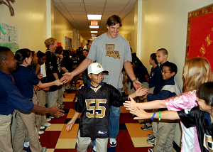 Scott Fujita, a member of the New Orleans Saints, greets more than 200 students of Belle Chasse Academy during a tour of the school as a part of the National Football League's Campaign 60 program. The NFL's Campaign 60 program is intended to encourage youth to exercise for 60 minutes a day. Belle Chasse Academy is the only NASA charter school on a military installation. U.S. Navy photo by Mass Communication Specialist 1st Class Shawn D. Graham (RELEASED)