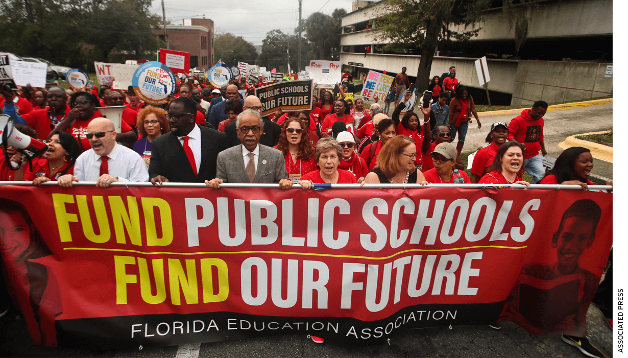 The Rev. Al Sharpton, front center, leads protestors as they march Monday, Jan. 13, 2020, during the Florida Education Association's "Take on Tallahassee" rally at the Old Capitol in Tallahassee, Fla.