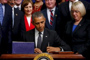 Obama signs the Every Student Succeeds Act into law in the Eisenhower Executive Office Building at the White House in Washington