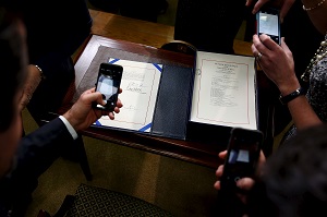 Guests take pictures of the Every Student Succeeds Act after U.S. President Barack Obama signed it into law. REUTERS/Jonathan Ernst