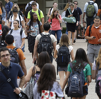 Students walk through the campus of the University of Texas at Austin. (Photo by Eric Gay/Corbis Images)