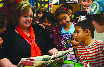 Lari Nelson, principal at Riverside’s Bryant school, reads to students.