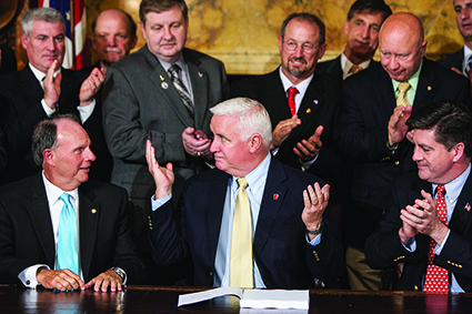 Pennsylvania governor Tom Corbett signs the 2013–14 state budget on June 30, 2013 AP Images / The Patriot-News, PennLive.com, Dan Gleiter