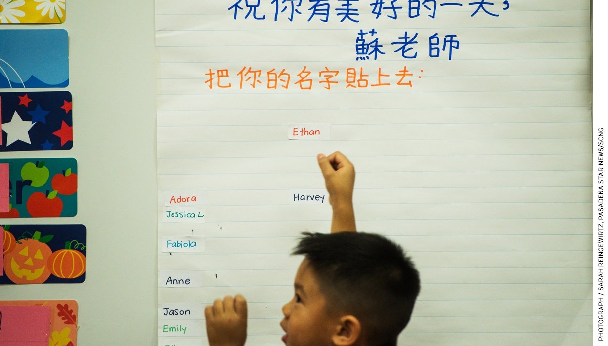 In Rowland Heights, Calif., Ethan Heng, 5, adds his name to a board that reads in Mandarin, "We can recognize our English names."