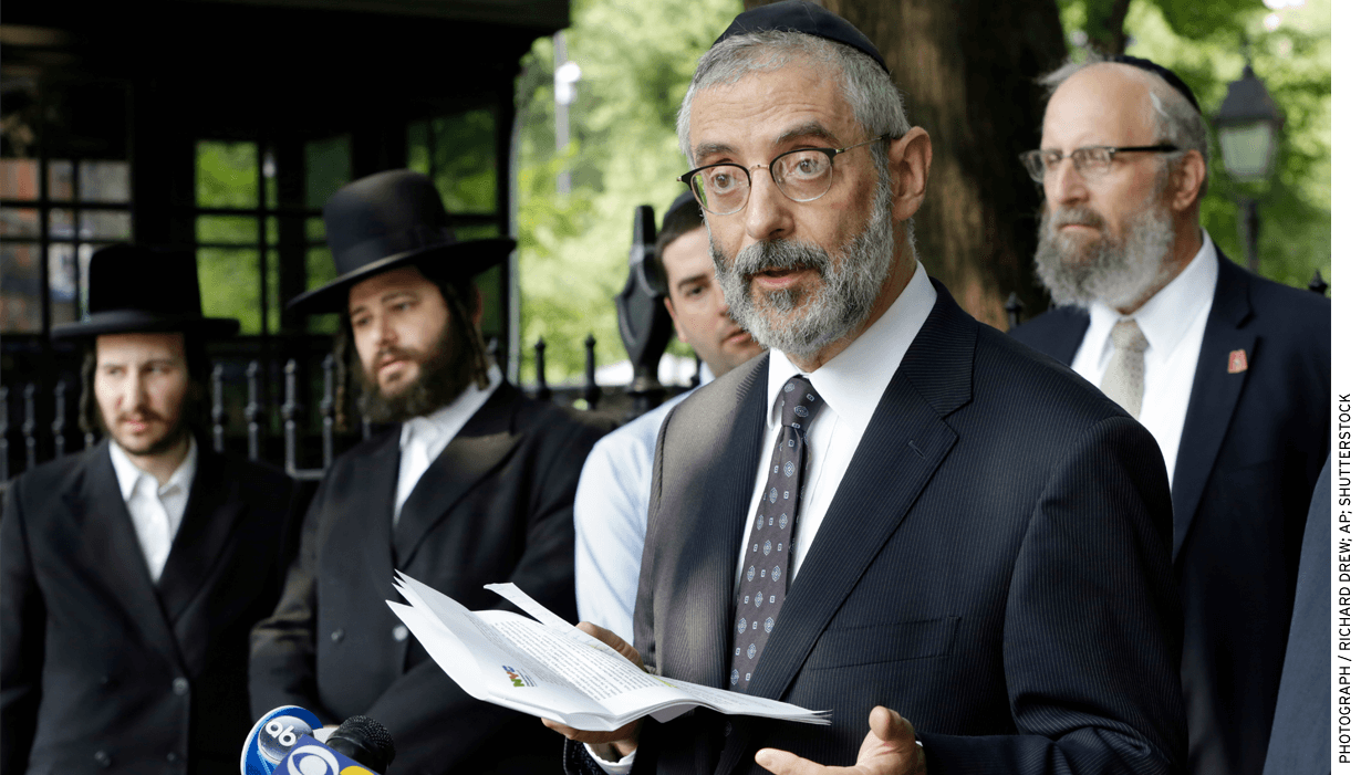 Rabbi Chaim Dovid Zwiebel, foreground, credits his Talmud study at a Jewish school in New York City as a help in eventually preparing him for law school.