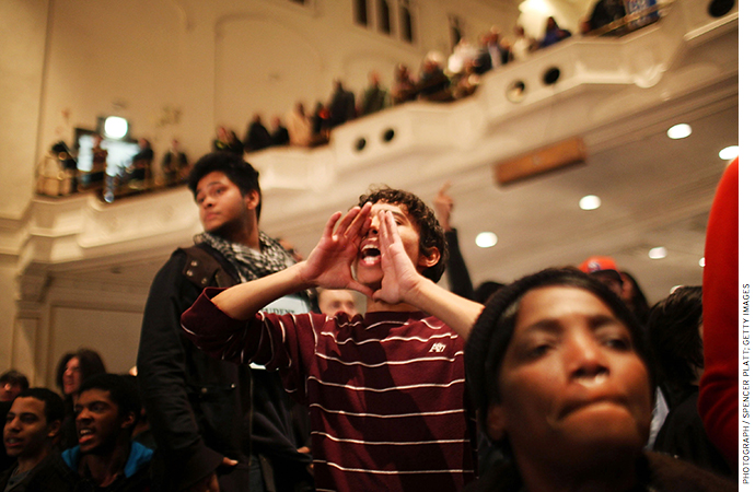 A student yells from the audience during a Panel for Educational Policy meeting in New York City in February 2012, before a vote on closing schools.