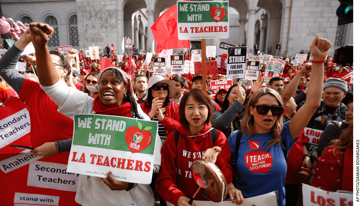 Teachers, parents and students picket outside City Hall in Los Angeles, Friday, Jan. 18, 2019, as part of a strike against Los Angeles Unified School District.