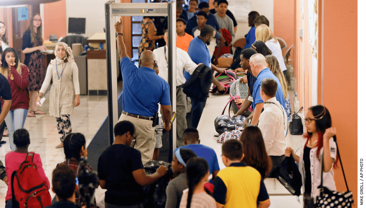 Students at William Hackett Middle School in Albany, N.Y., have their bags checked and pass through metal detectors on their way into their school.