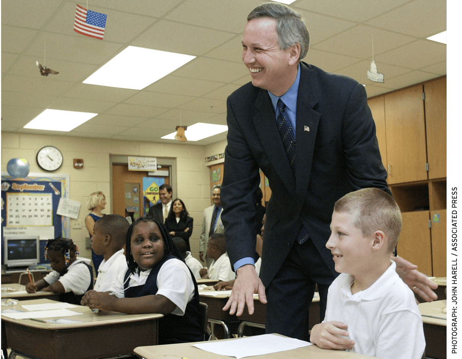 Mayor Bart Peterson visits with 3rd graders during the first day of classes in 2002 at Christel House Academy, a charter school.