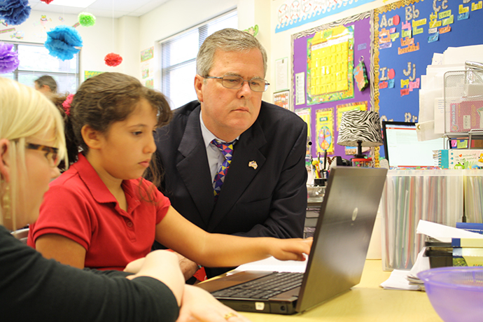 Governor Bush with a student during a visit to Reasoning Mind Photo: Joe Burbank / Courtesy Foundation for Excellence in Education