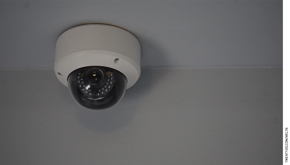 A security camera mounted on a ceiling.