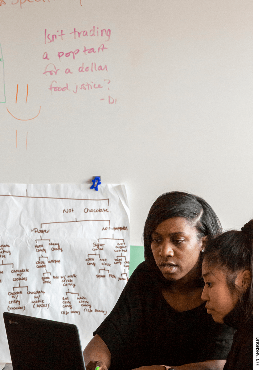 Eleventh grader Elma Miranda-Ramirez works with dedicated aide Tatiana Hyman in environmental science class to research where the meals Capital City Public Charter School serves are made.