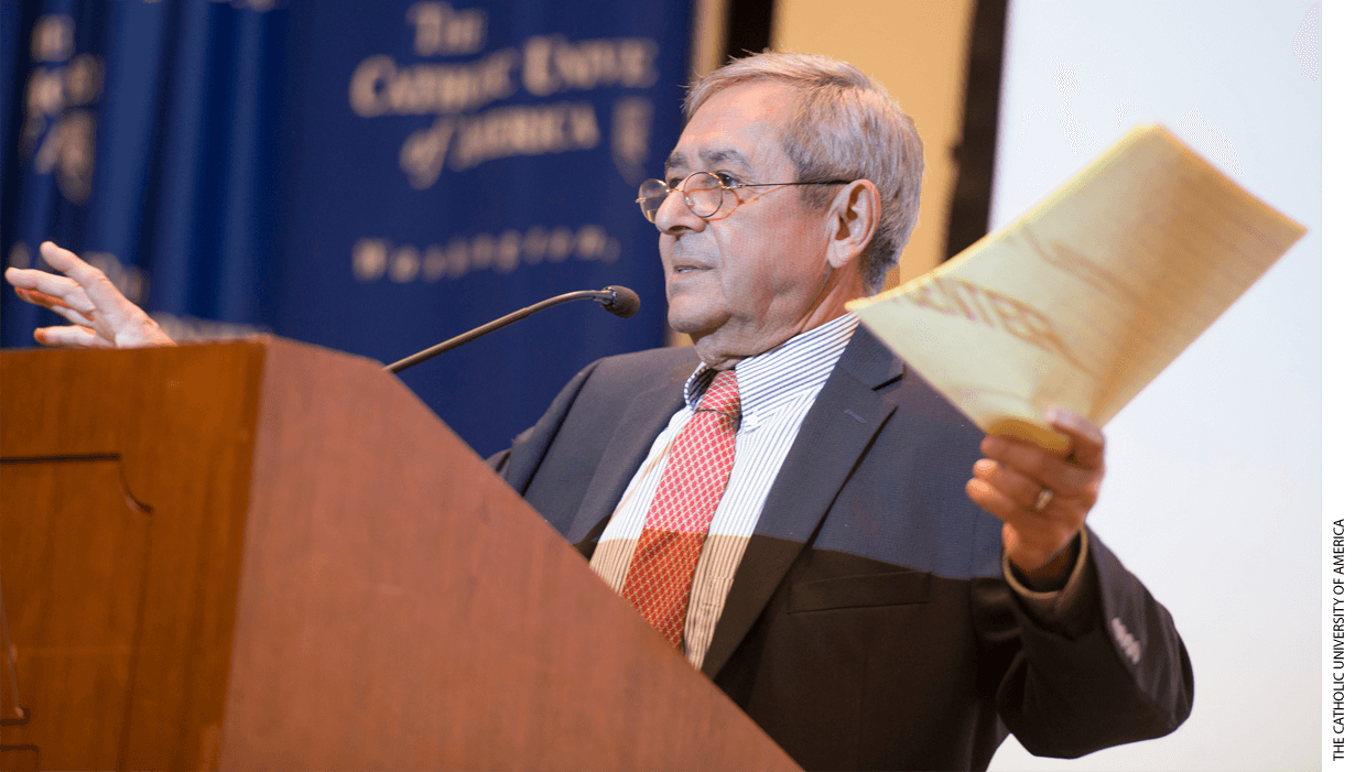 James Youniss, professor emeritus of Catholic University, speaking at a podium.