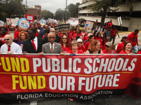 The Rev. Al Sharpton, front center, leads protestors as they march Monday, Jan. 13, 2020, during the Florida Education Association's "Take on Tallahassee" rally at the Old Capitol in Tallahassee, Fla.