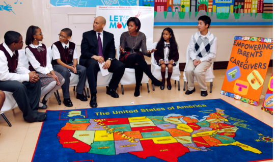First Lady Michelle Obama and Newark Mayor Cory Booker sit with children at the Maple Avenue School in Newark, N.J., Thursday, Nov. 18, 2010.