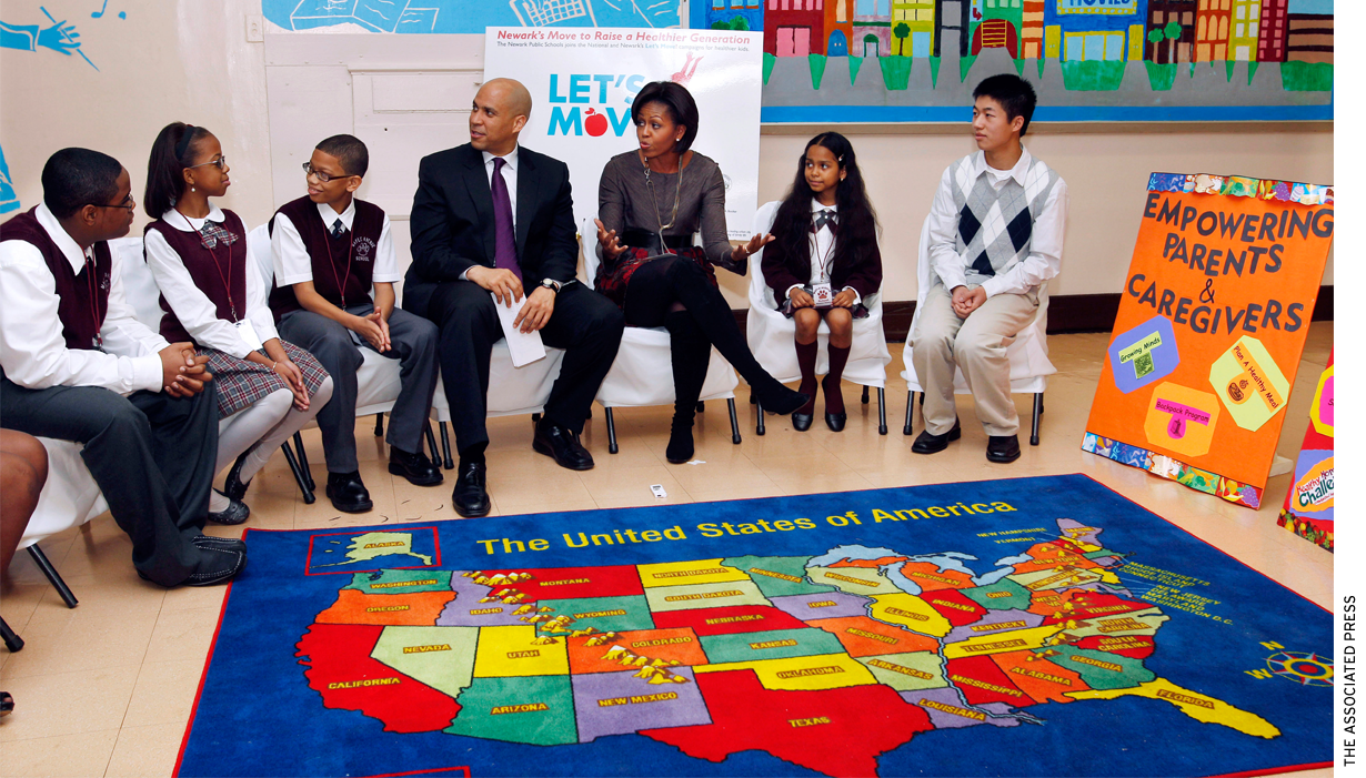 First Lady Michelle Obama and Newark Mayor Cory Booker sit with children at the Maple Avenue School in Newark, N.J., Thursday, Nov. 18, 2010.