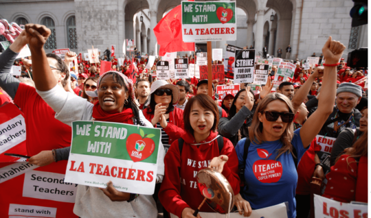 Teachers, parents and students picket outside City Hall in Los Angeles, Friday, Jan. 18, 2019, as part of a strike against Los Angeles Unified School District.