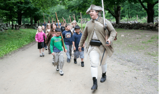 Park Ranger Jim Hollister leads a school group at Minute Man National Historical Park in Massachusetts.
