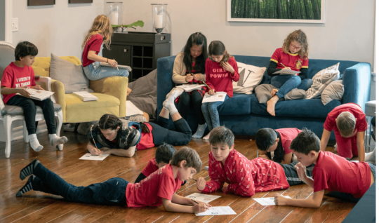 Students from L.A. Unified's Encino Charter Elementary School —dressed in red to support their teachers—attended a community- organized “strike school” in an Encino, Calif., home. Parents took turns hosting children during the teacher strike.