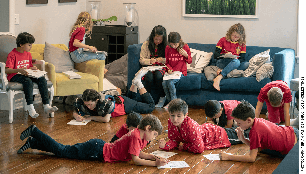 Students from L.A. Unified's Encino Charter Elementary School —dressed in red to support their teachers—attended a community- organized “strike school” in an Encino, Calif., home. Parents took turns hosting children during the teacher strike.