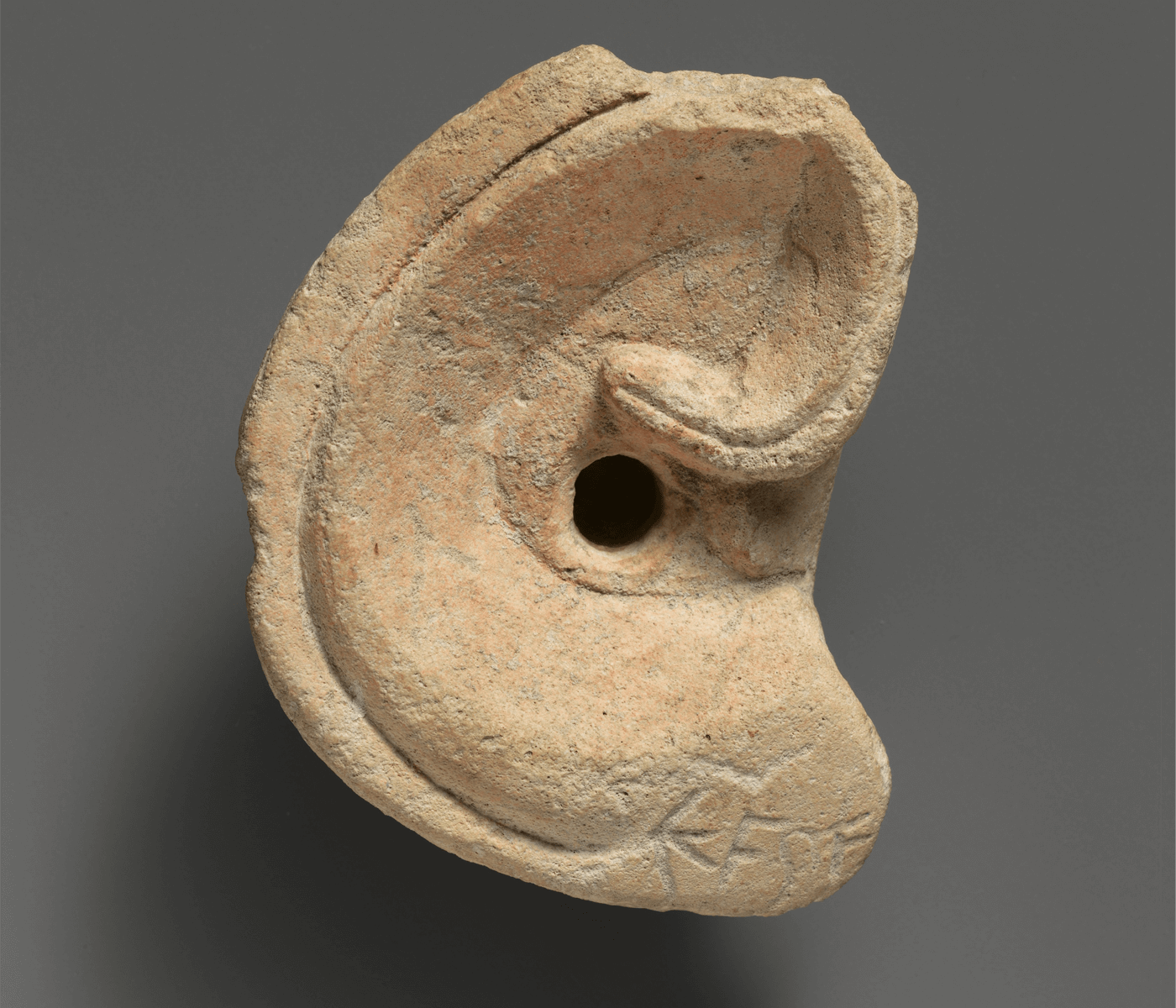 A Cypriot limestone votive ear, 4th-3rd century B.C.