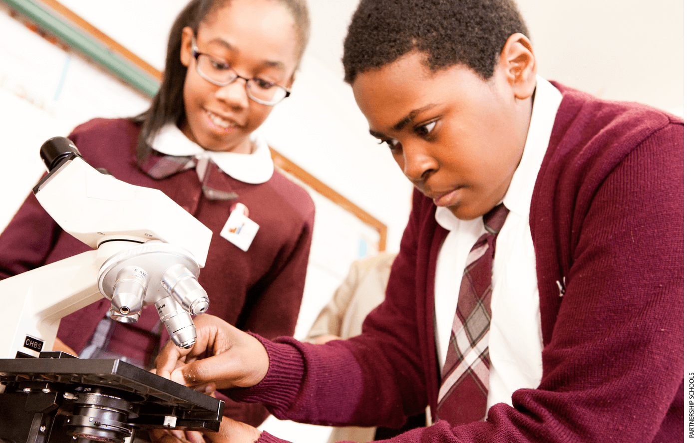 Students at Mt. Carmel-Holy Rosary School Catholic Elementary School in New York, N.Y., using a microscope