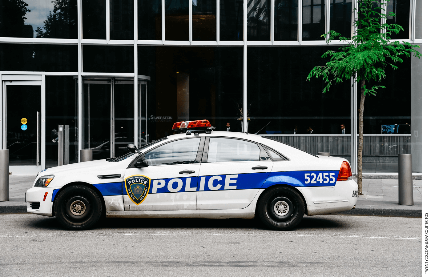 A police car parked in front of an office building
