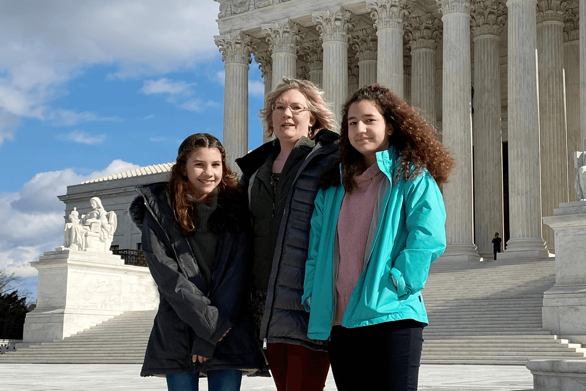 Montana resident Kendra Espinoza poses in front of the white-marble court building with her daughters Naomi (right) and Sarah (left) in Washington, D.C., on January 19, 2020.