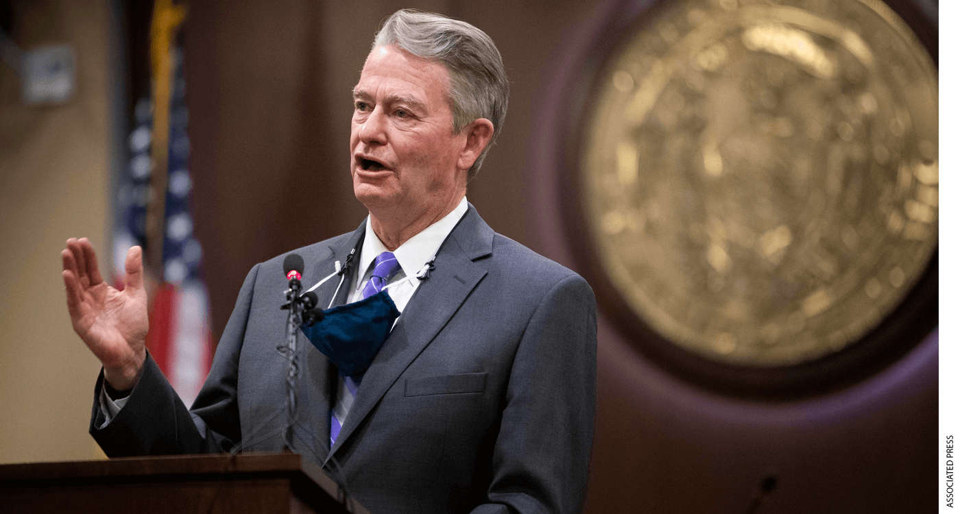 Idaho Governor Brad Little speaking at a podium