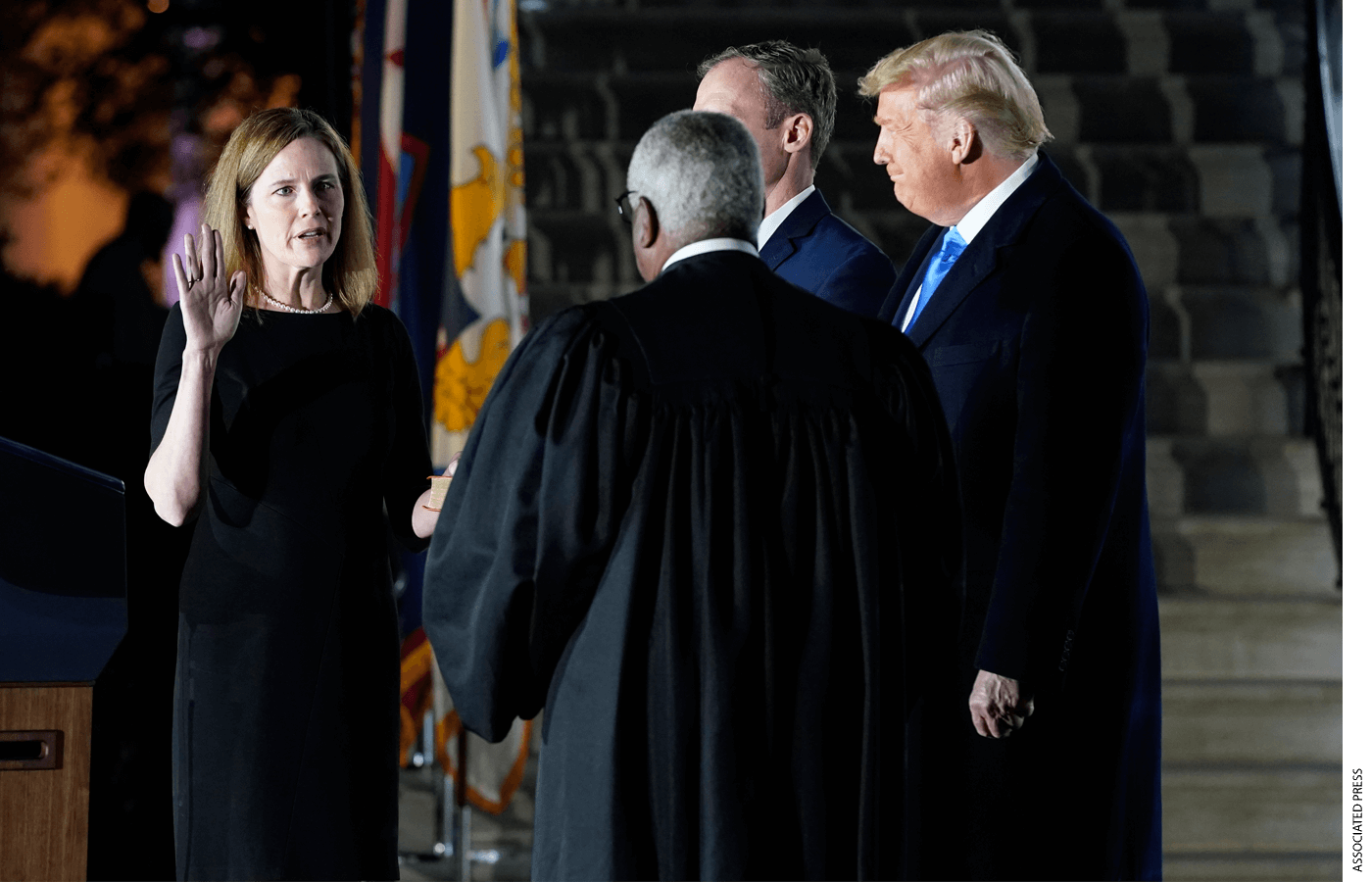 President Donald Trump watches as Supreme Court Justice Clarence Thomas administers the Constitutional Oath to Amy Coney Barrett on the South Lawn of the White House in Washington, Monday, Oct. 26, 2020, after Barrett was confirmed by the Senate earlier in the evening.