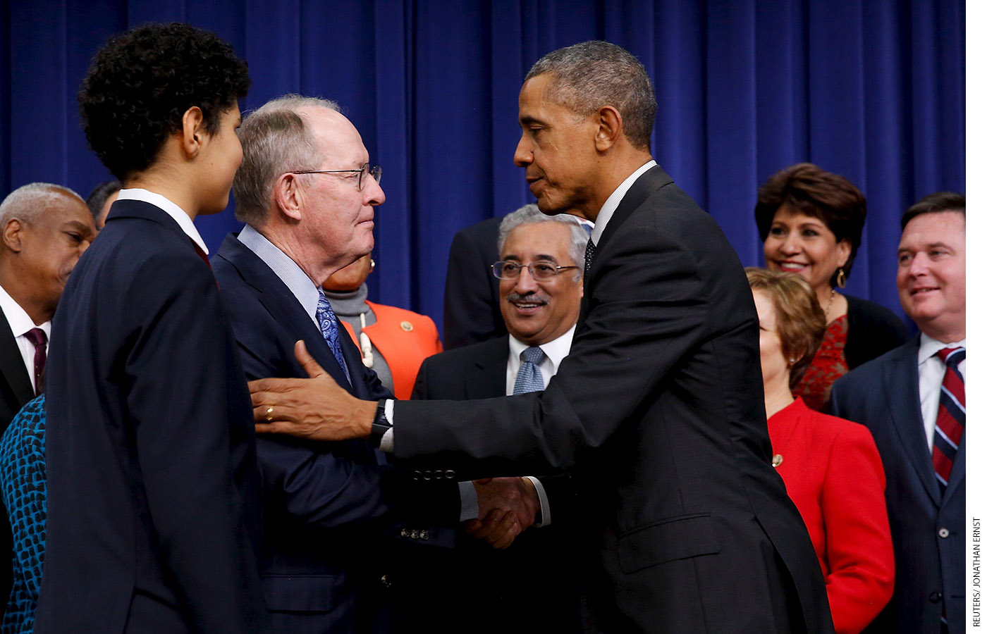 President Barack Obama shakes hands with Alexander after signing the Every Student Succeeds Act into law on December 10, 2015.