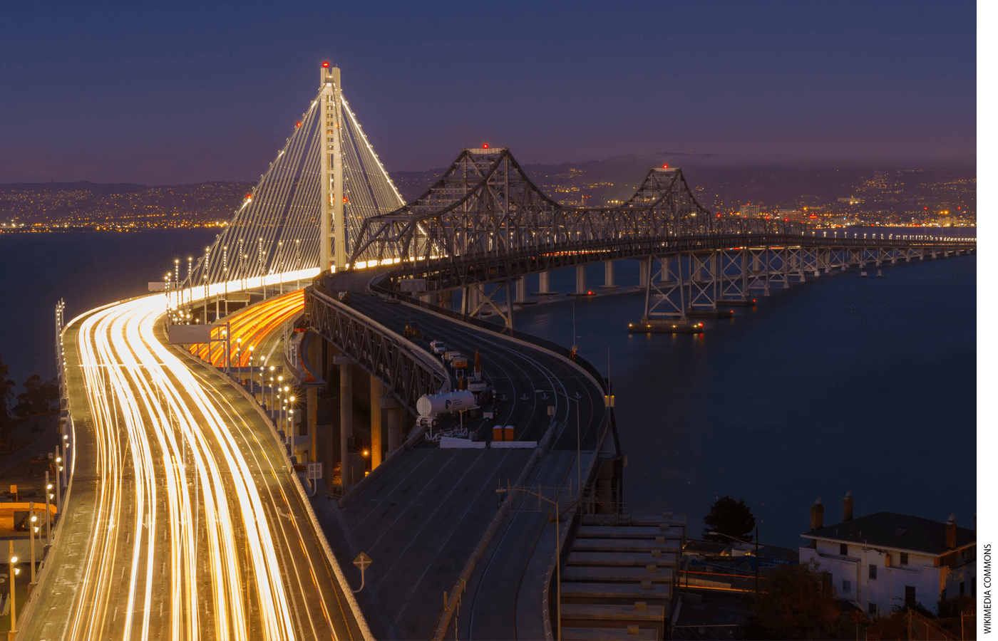 A photo of an old bridge next to a new bridge