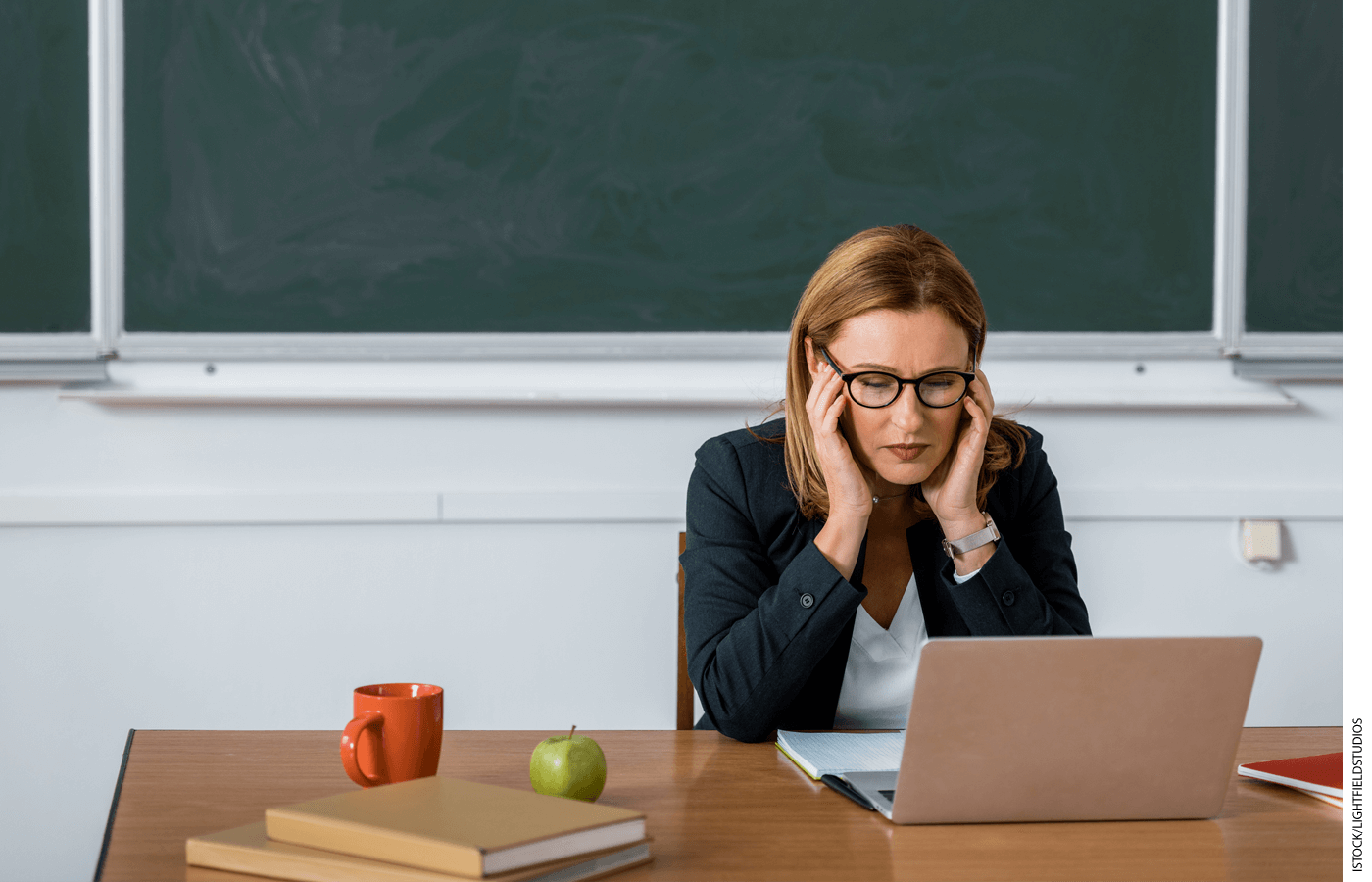 Teacher looking at laptop