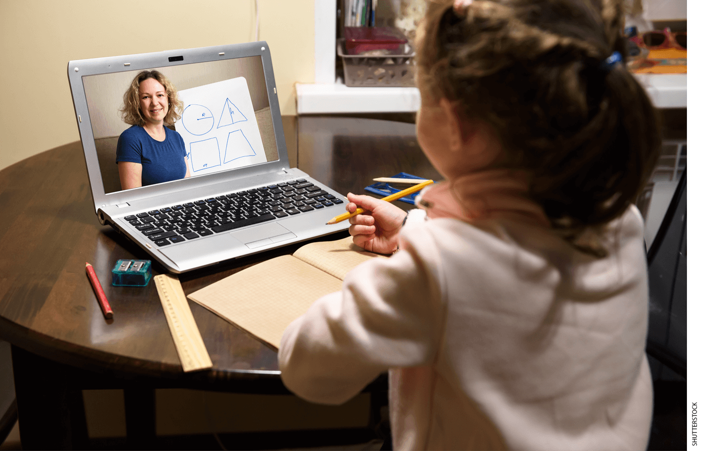 A student follows along with a school lesson on a laptop.