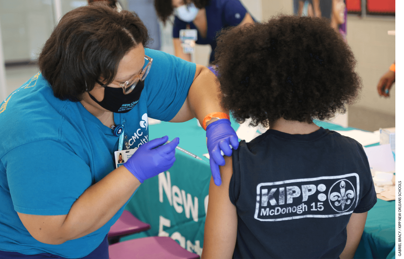 A person receives a Covid-19 vaccination in a school