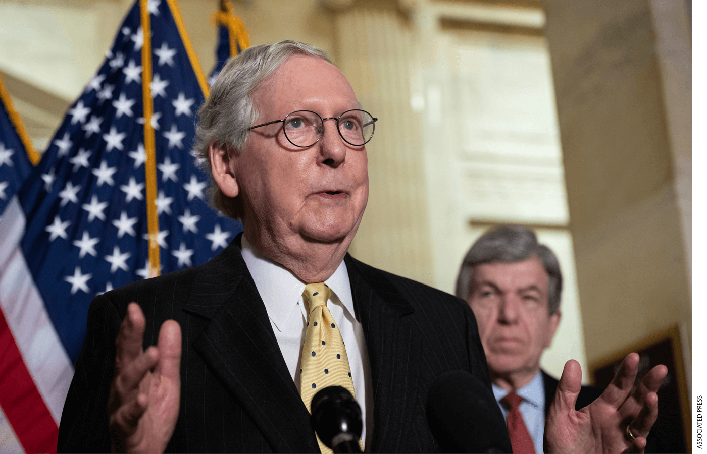 Photo of Sen. Mitch McConnell speaking from behind a podium