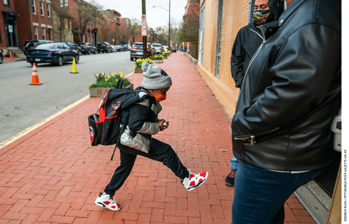 First grader Jaion Pollard arrives at Manchester Academic Charter School in Pittsburgh on the first day of in-person learning on a hybrid schedule, March 29, 2021.