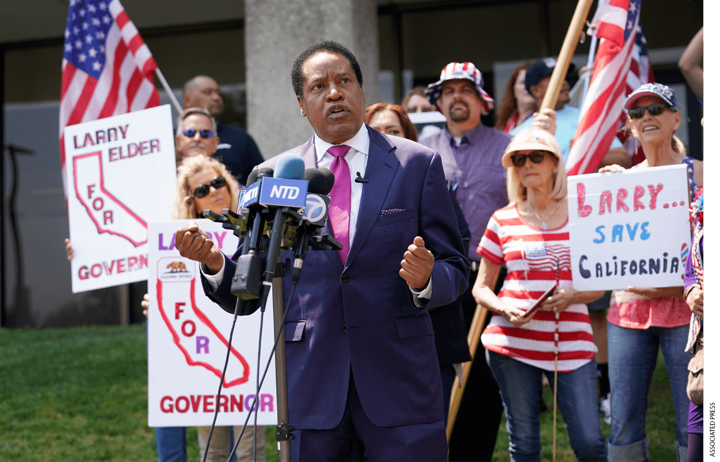 In this July 14, 2021, file photo, radio talk show host Larry Elder speaks to supporters during a campaign stop in Norwalk, Calif. Elder, who is running to replace Democratic Gov. Gavin Newsom in the Sept. 14 recall election, says he would erase state vaccine and mask mandates, is critical of gun control, opposes the minimum wage and disputes the notion of systemic racism in America.