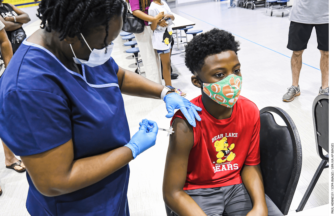 A 12-year-old boy gets vaccinated in Florida.