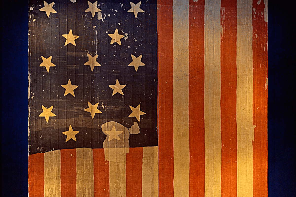 The original Star-Spangled Banner, which flew over Fort McHenry in 1814 and inspired the words of our National Anthem, as it was displayed in what is now the National Museum of American History.