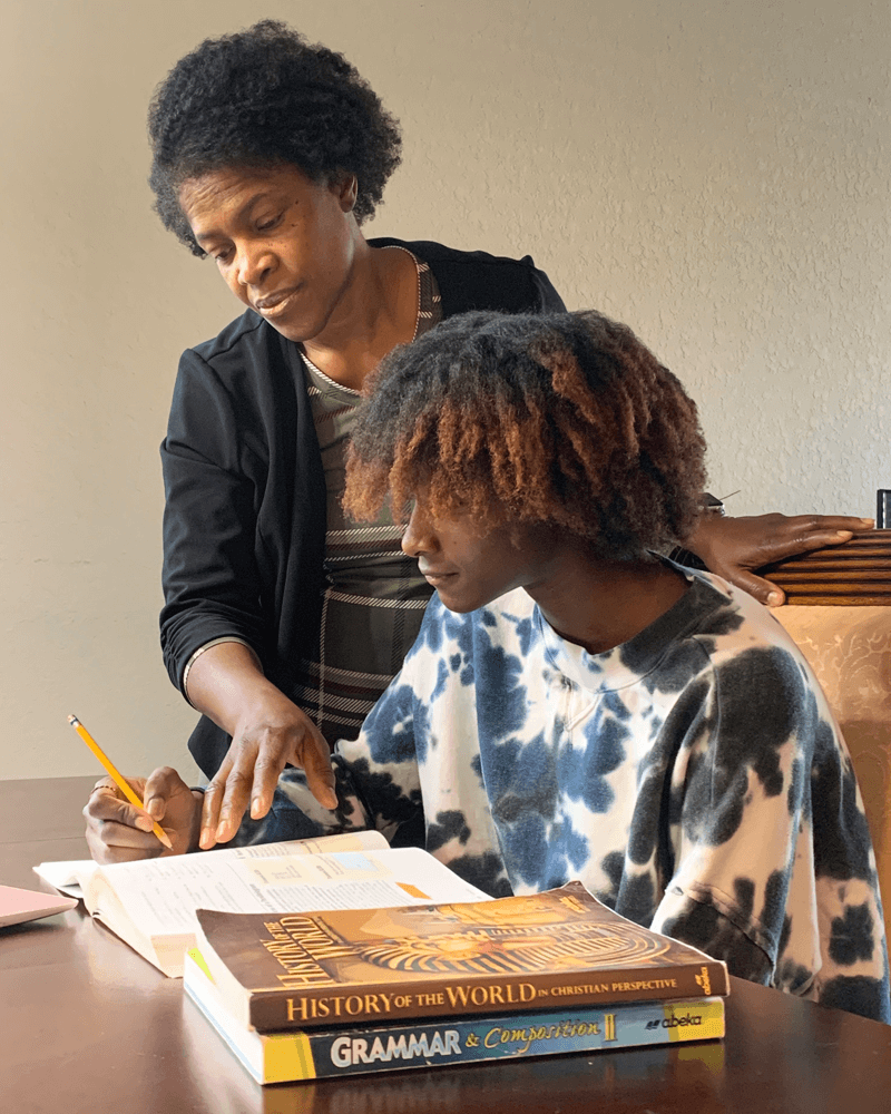 Valerie Bryant helps her daughter with homework.