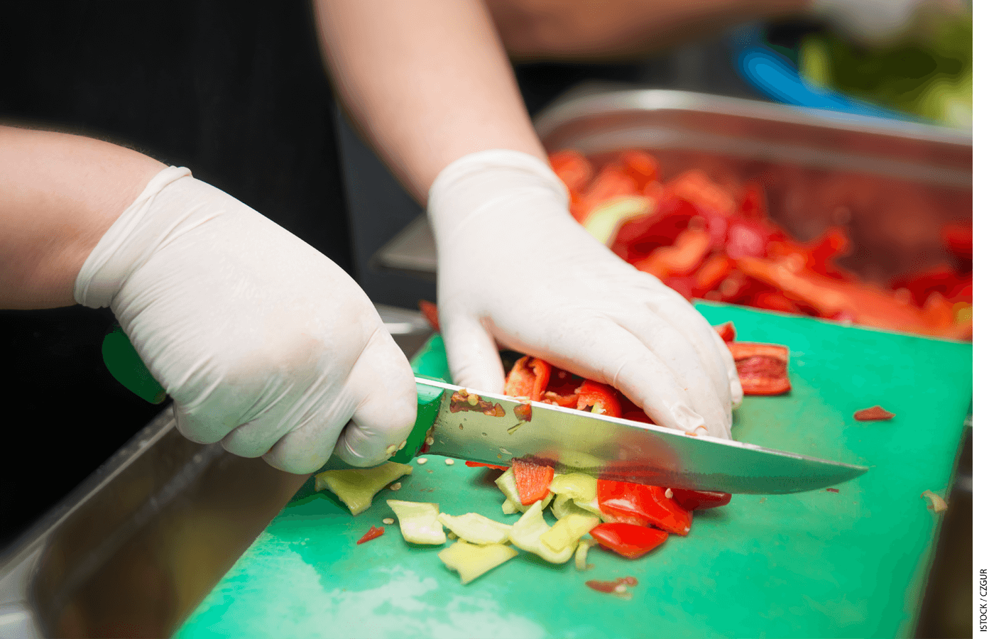 A restaurant worker chops vegetables