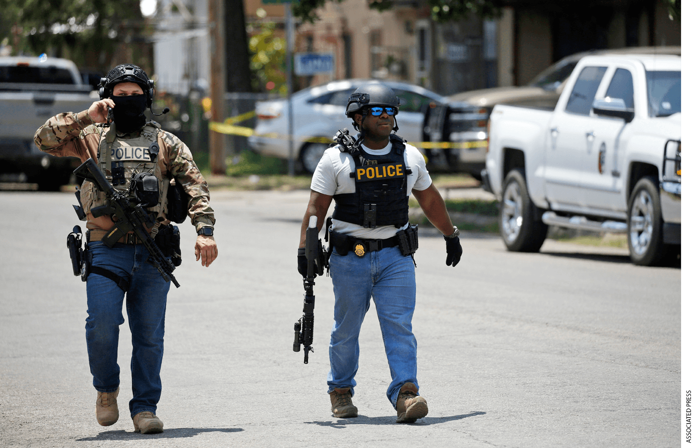 Police walk near Robb Elementary School following a shooting, Tuesday, May 24, 2022, in Uvalde, Texas.