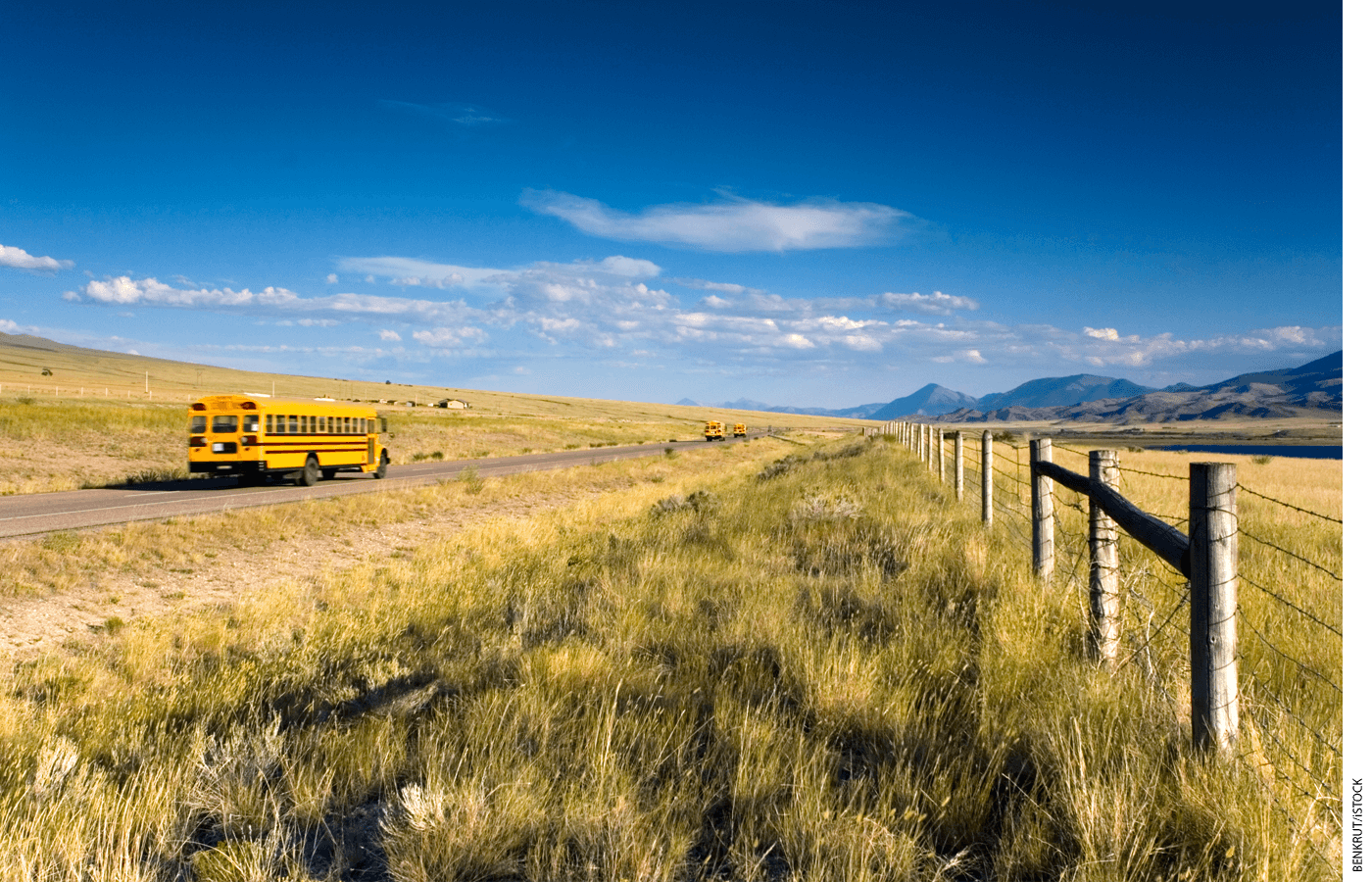 A bus drives down a rural road.