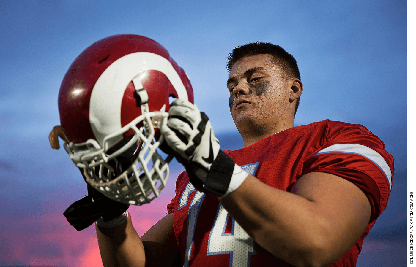 Shane Lemieux, a offensive tackle for the West Valley High School Rams varsity football team and 17-year-old native of Yakima, Wash., dons his helmet before a game against the Wenatchee High School Panthers at West Valley High School in Yakima, Wash., Oct. 31, 2014.