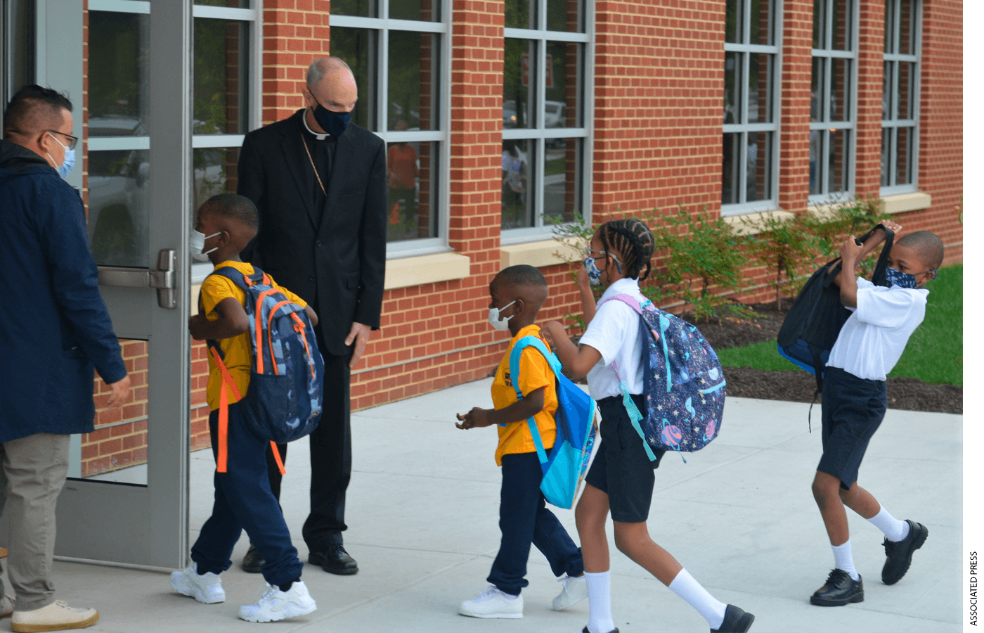 Youngsters enter the first new Catholic school built in Baltimore in roughly 60 years with a mix of enthusiasm and first-day-back jitters, Monday Aug. 30, 2021.