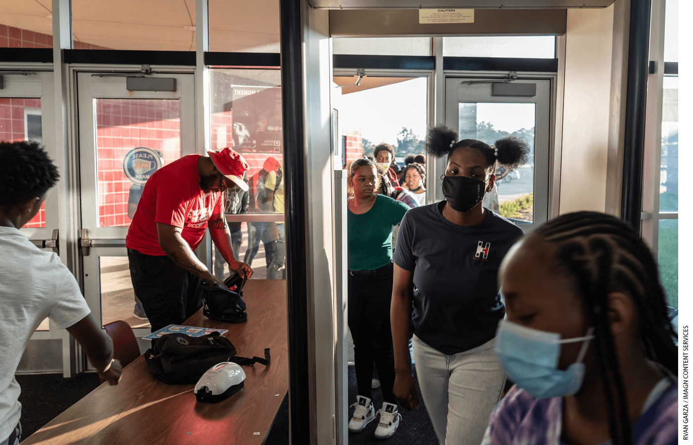 At Ecorse High School in Michigan, an example of target hardening: students go through a metal detector and have their bags searched by security as they enter the school building.
