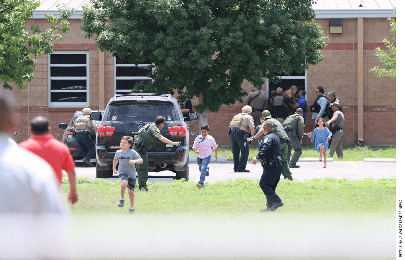Students run from Robb Elementary School in Uvalde, Texas, during the mass shooting there on May 24, 2022.